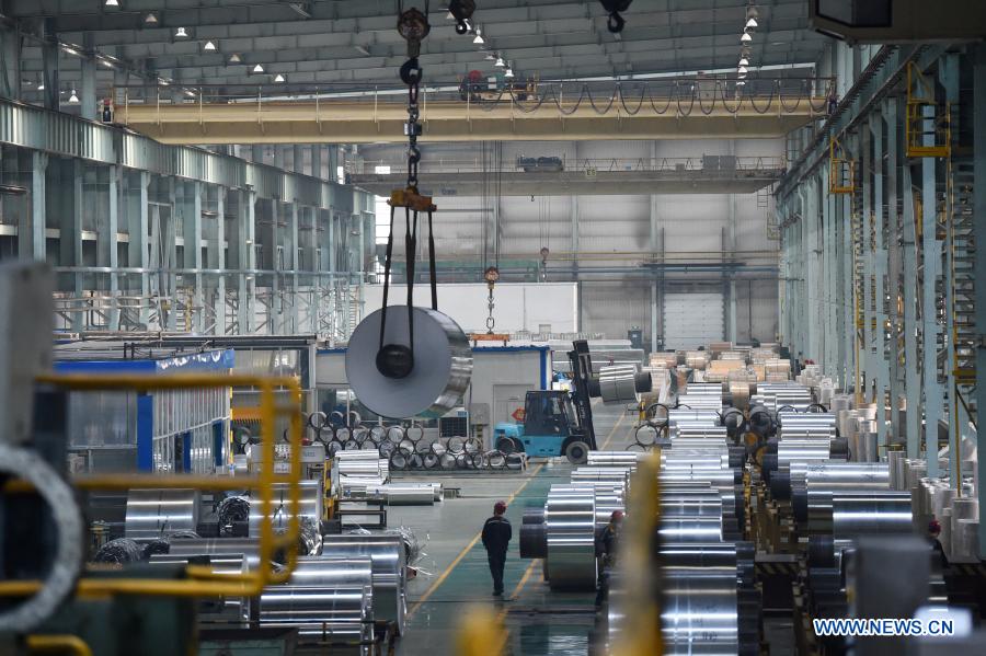 Staff members work at workshop of Light Alloy company in Harbin