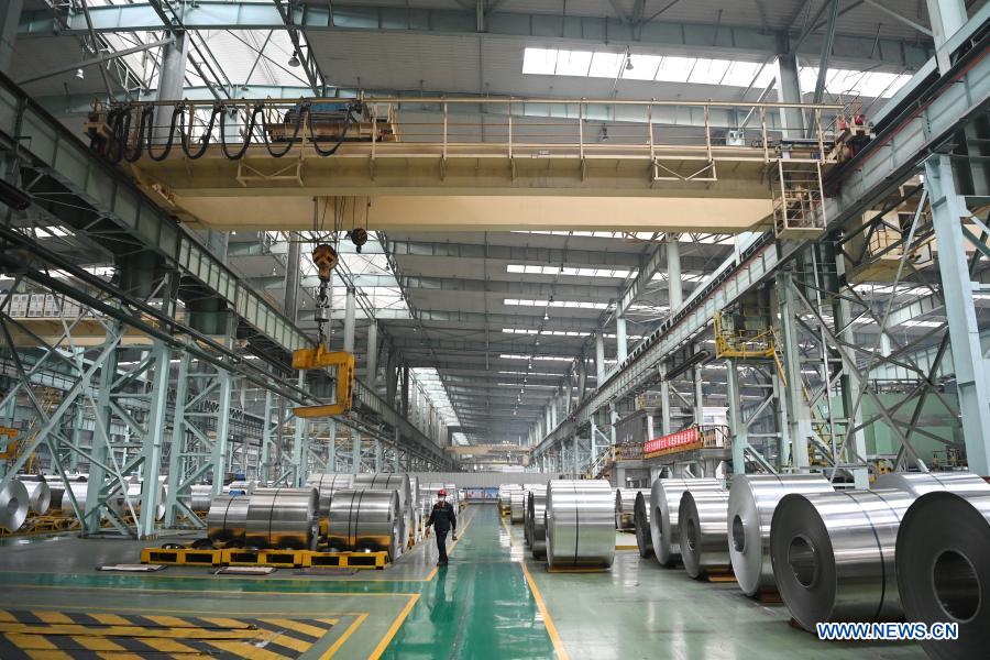 Staff members work at workshop of Light Alloy company in Harbin