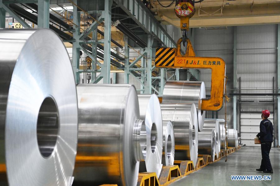 Staff members work at workshop of Light Alloy company in Harbin