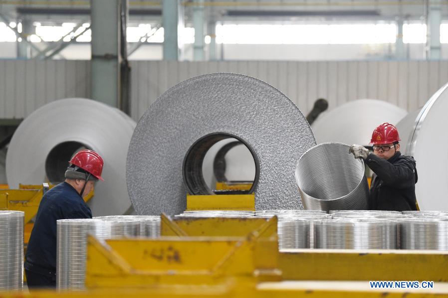 Staff members work at workshop of Light Alloy company in Harbin