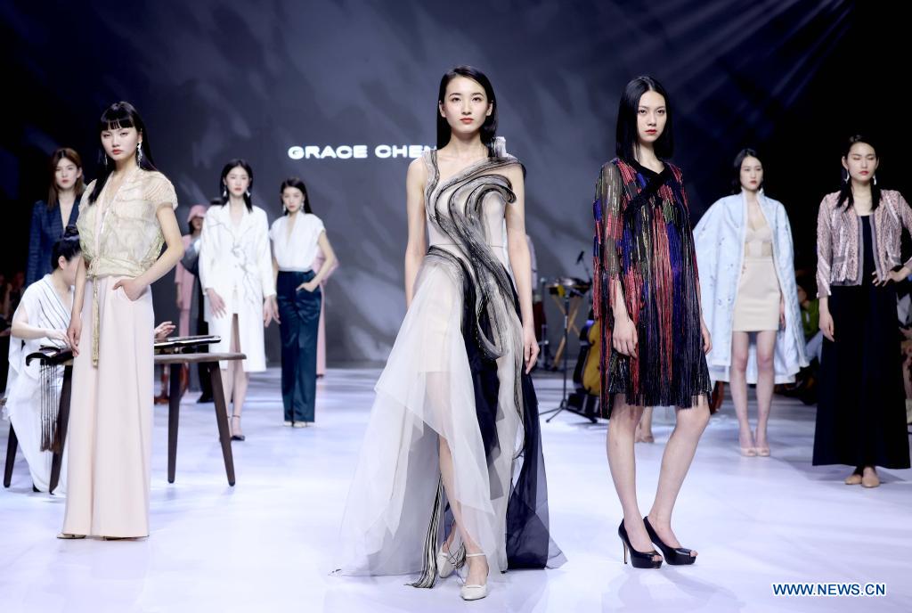 Models present creations of Grace Chen during China Fashion Week in Beijing