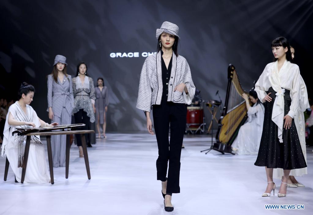 Models present creations of Grace Chen during China Fashion Week in Beijing