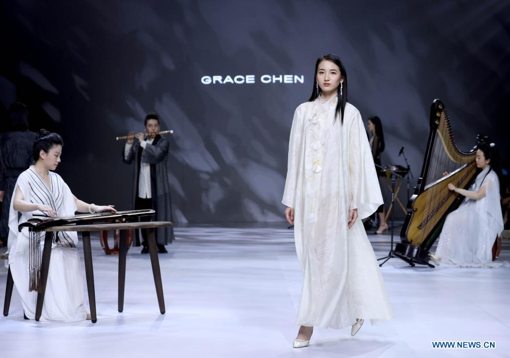 Models present creations of Grace Chen during China Fashion Week in Beijing