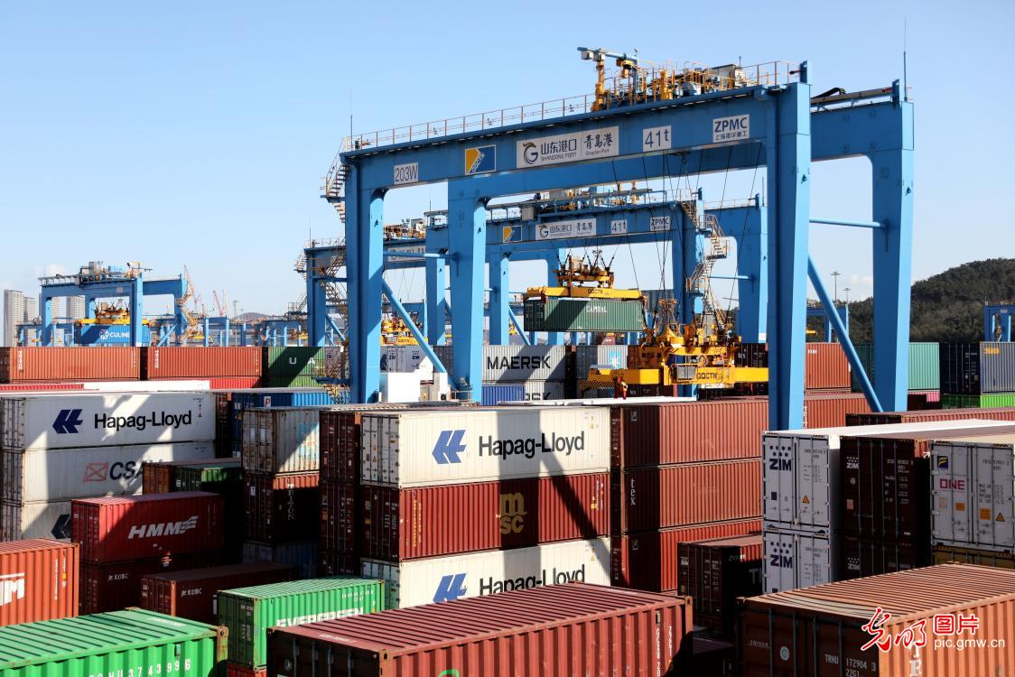 Trucks load cargos at smart terminal of Qingdao Port