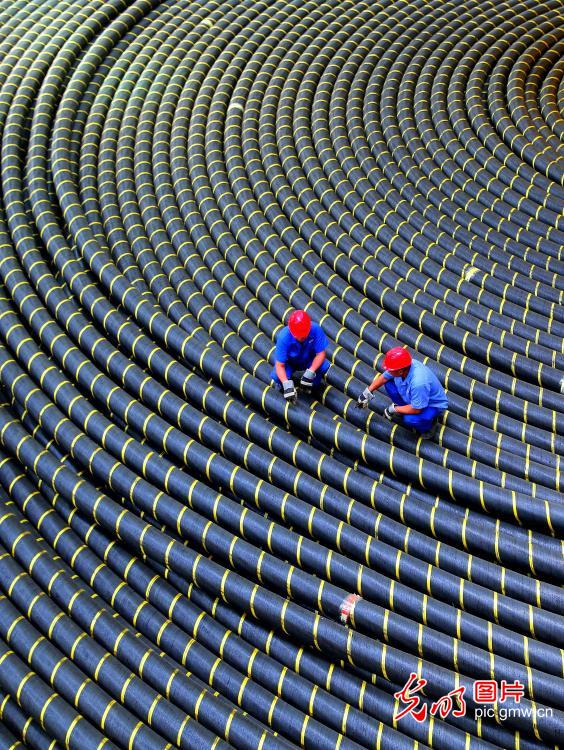 Workers inspecting submarine cable products in E China's Shandong