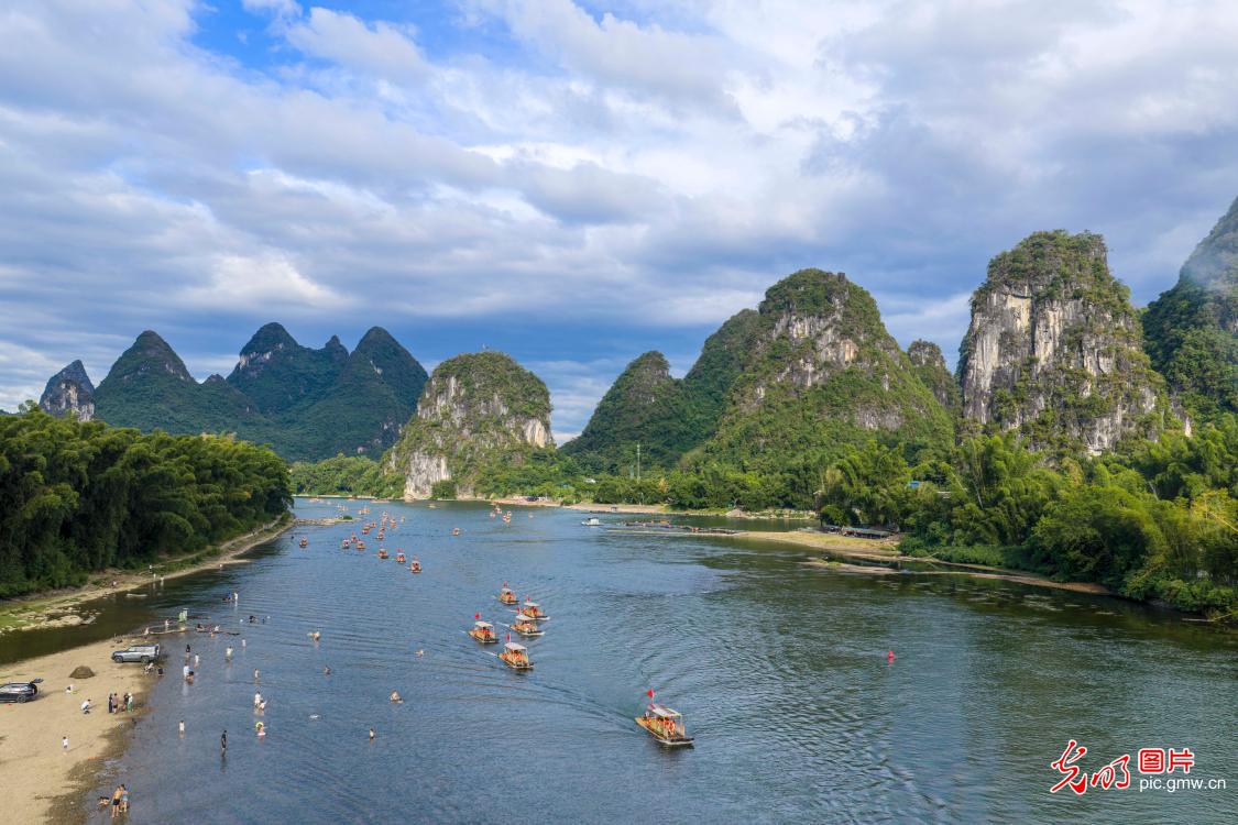 Electric rafts ply scenic Lijiang River during holiday