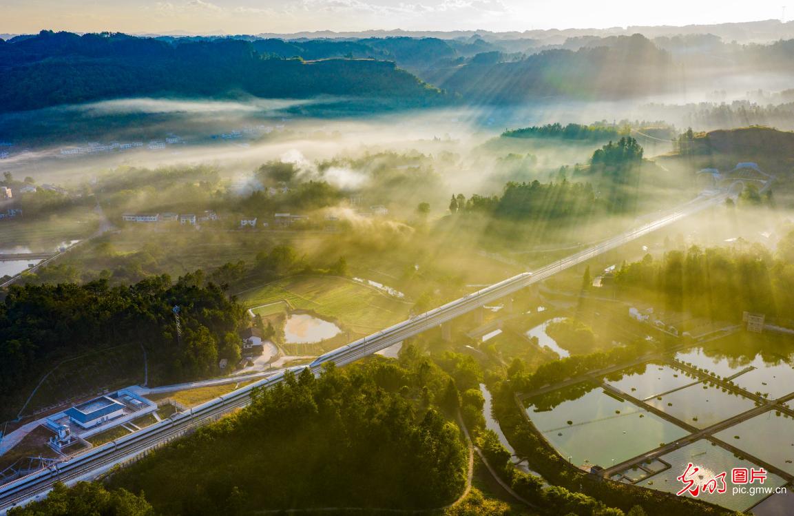 Morning light pierces the veil of mist over rural areas of Chongqing in SW China Morning light pierces the veil of mist over rural areas of Chongqing in SW China