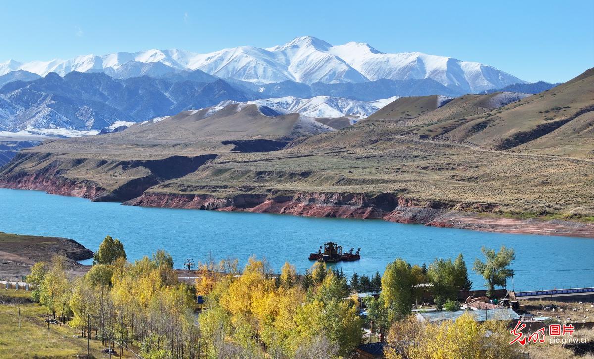 Mirror-like reservoir meets vibrant autumn tones