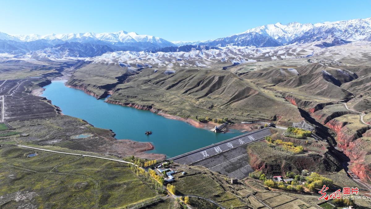 Mirror-like reservoir meets vibrant autumn tones