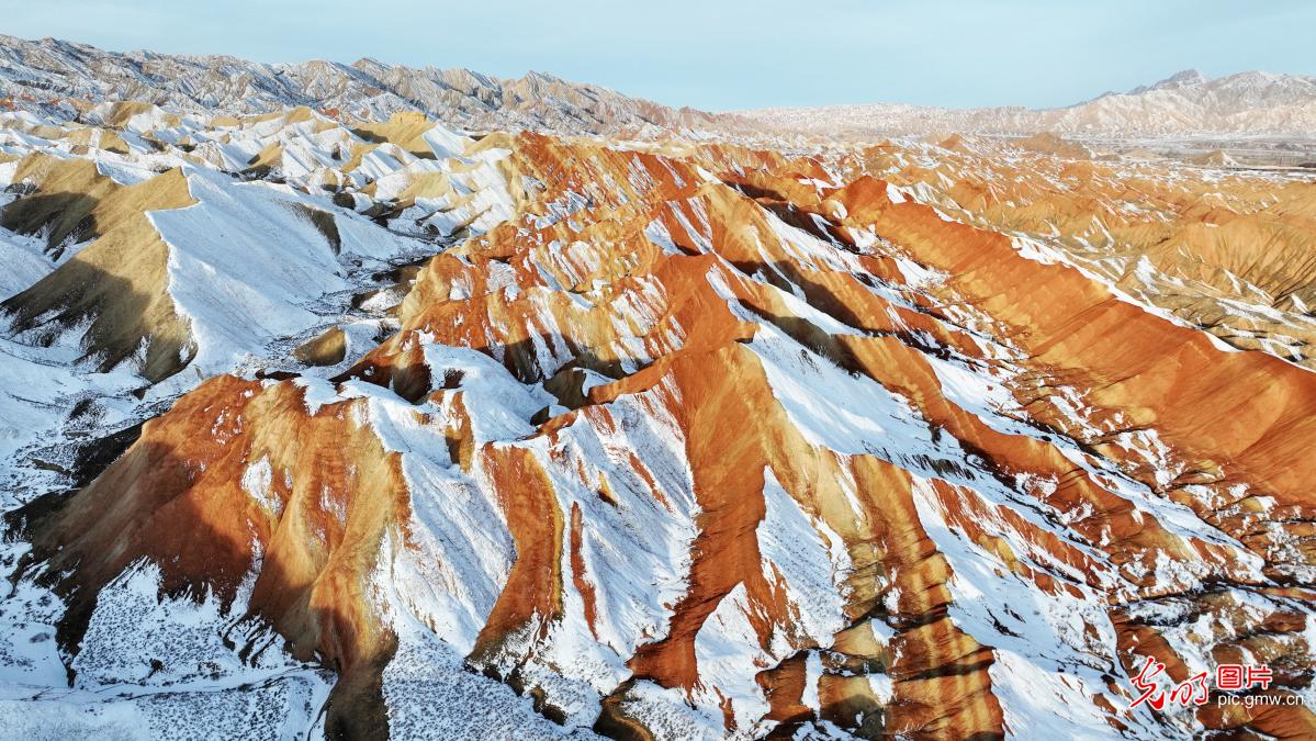 Colorful danxia mountains in Zhangye glow amid winter snow