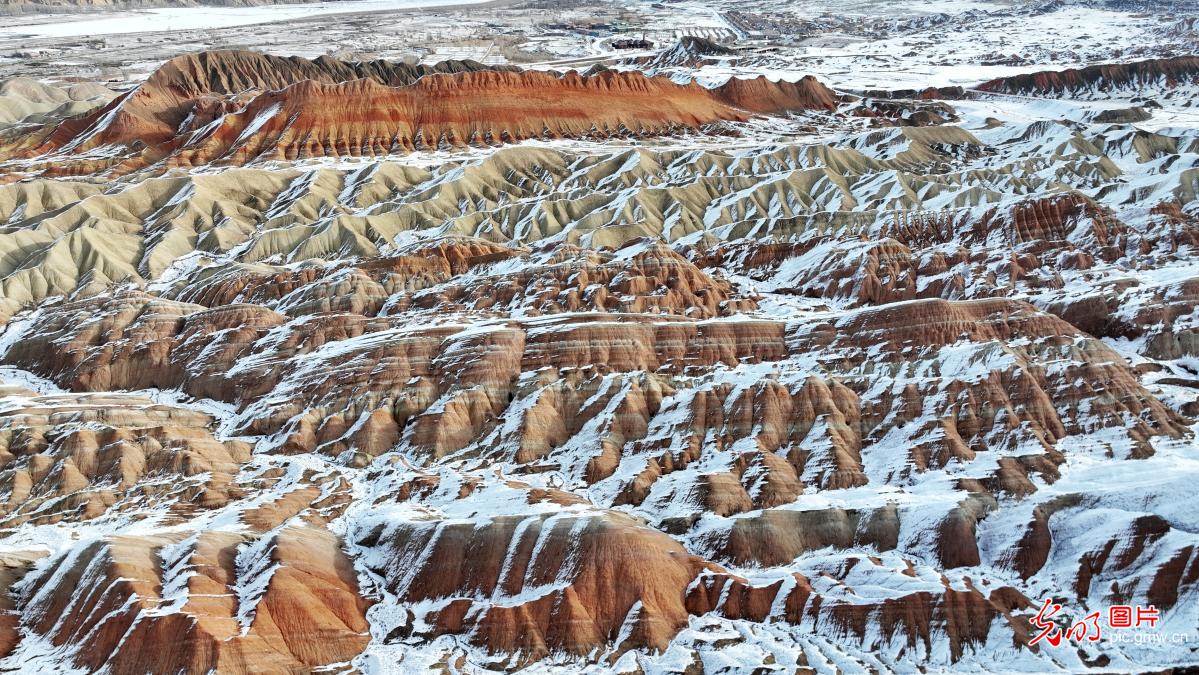 Colorful danxia mountains in Zhangye glow amid winter snow