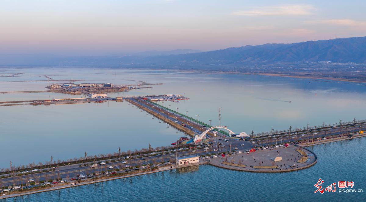 Colorful salt lake reflects winter sky