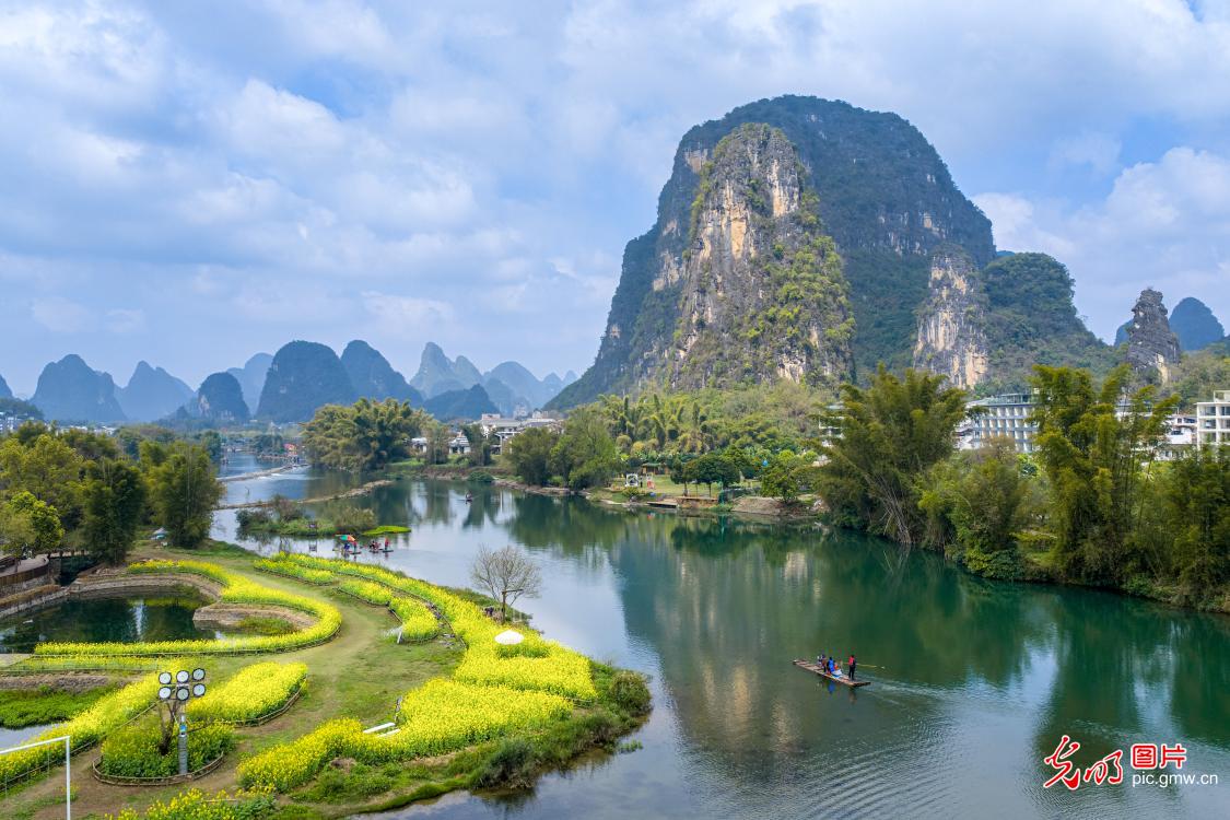 Tourists enjoy spring scenery along the Yulong River in Yangshuo