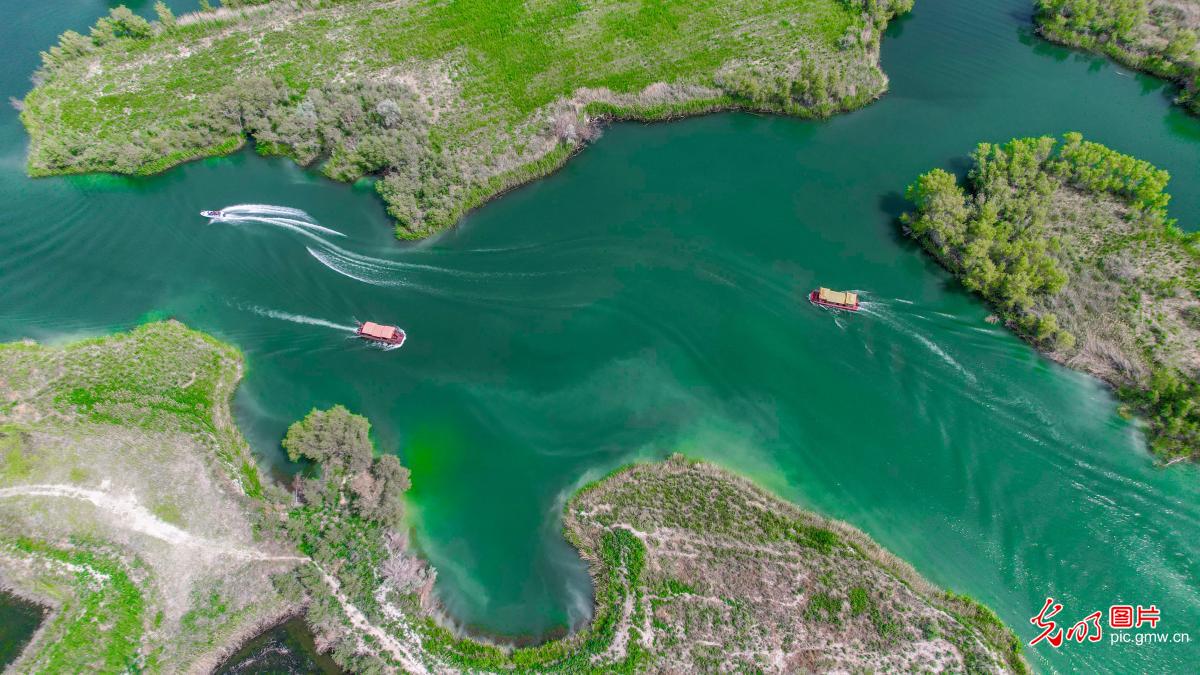 Boat tour on Kezijar Lake Scenic Area in NW China's Xinjiang