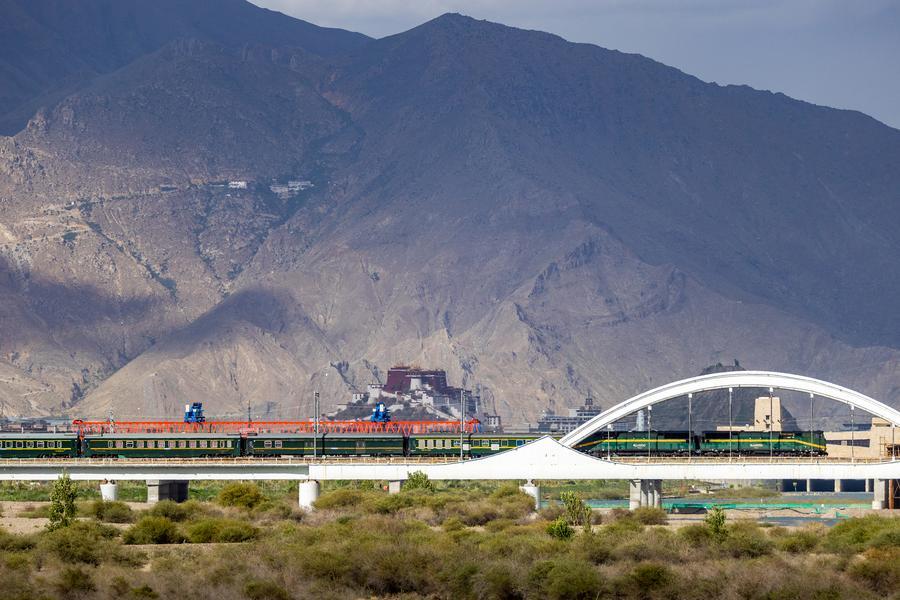 Qinghai-Xizang Railway pictured against the Potala Palace in SW China's Lhasa