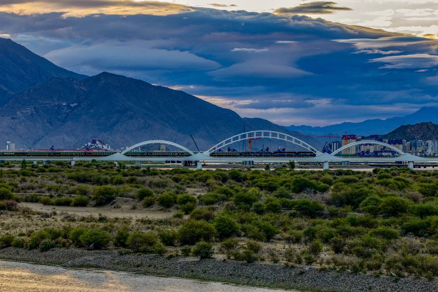 Qinghai-Xizang Railway pictured against the Potala Palace in SW China's Lhasa