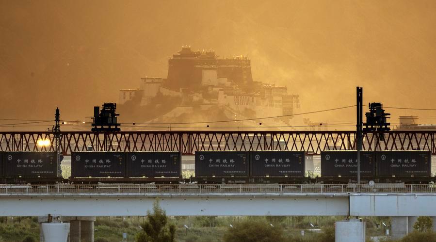 Qinghai-Xizang Railway pictured against the Potala Palace in SW China's Lhasa