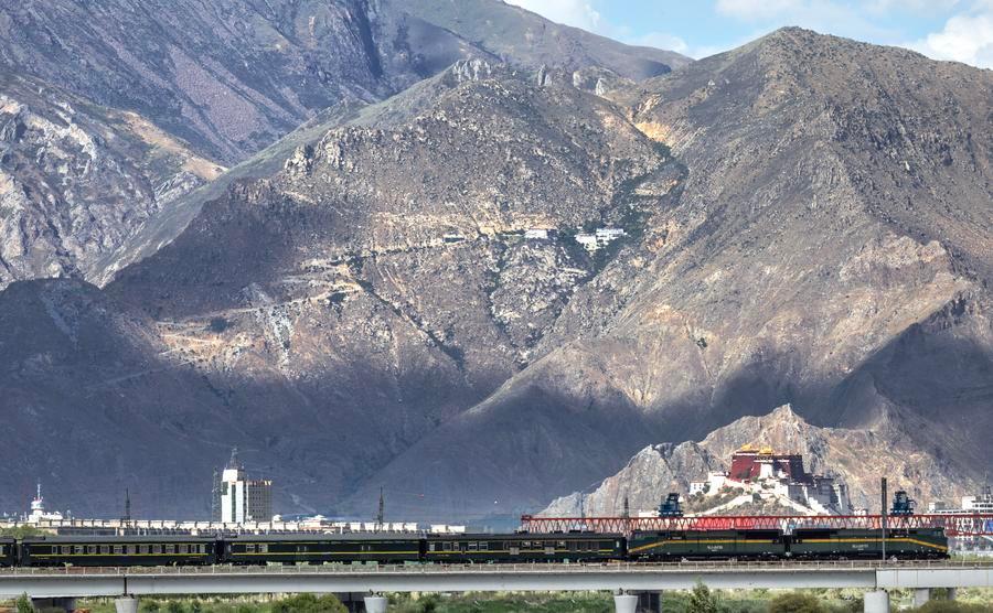 Qinghai-Xizang Railway pictured against the Potala Palace in SW China's Lhasa