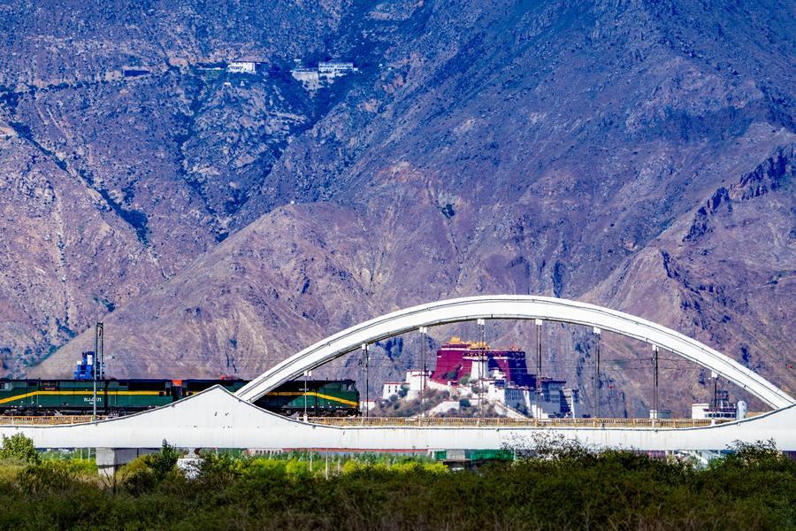 Qinghai-Xizang Railway pictured against the Potala Palace in SW China's Lhasa