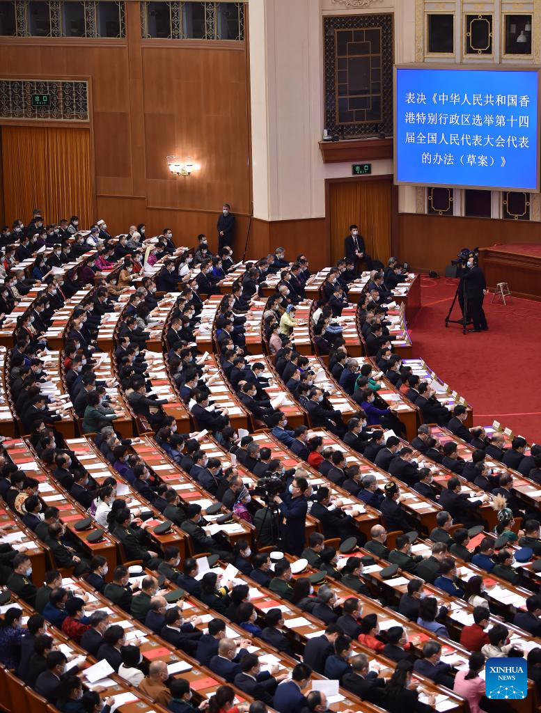 China's national legislature holds closing meeting of annual session