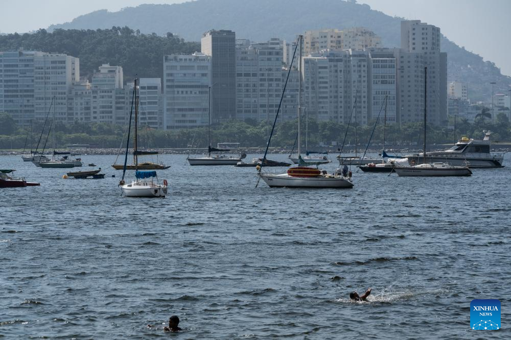 People cool off on beach in Rio de Janeiro