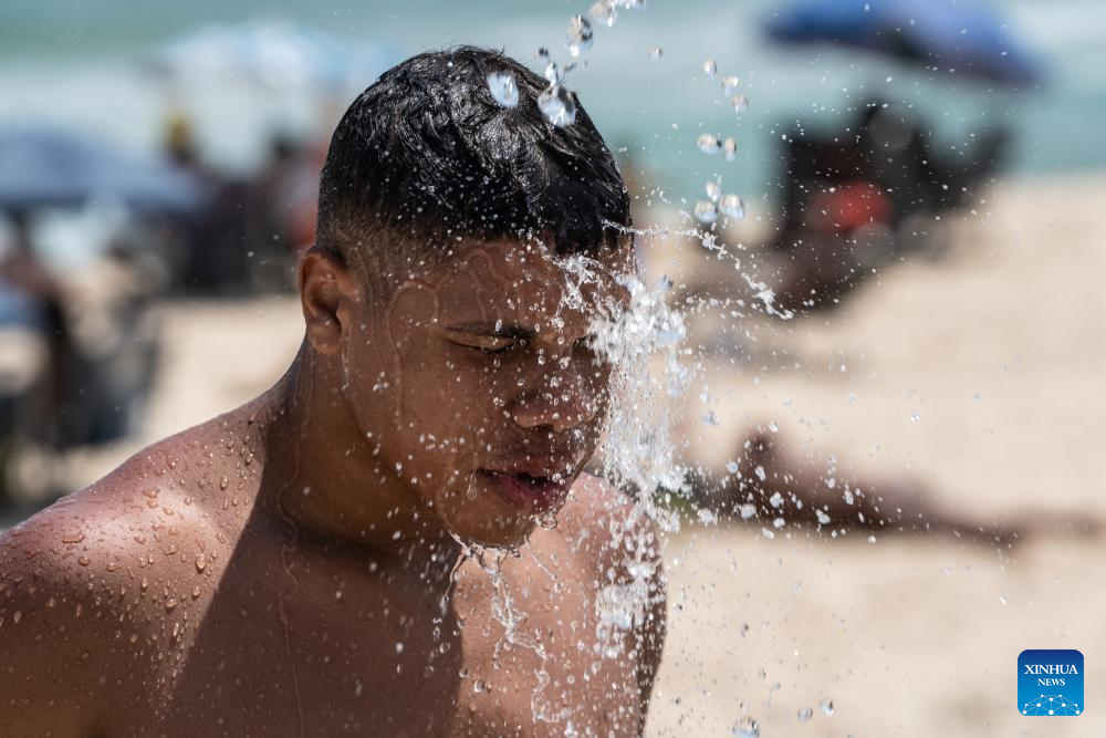 People cool off on beach in Rio de Janeiro