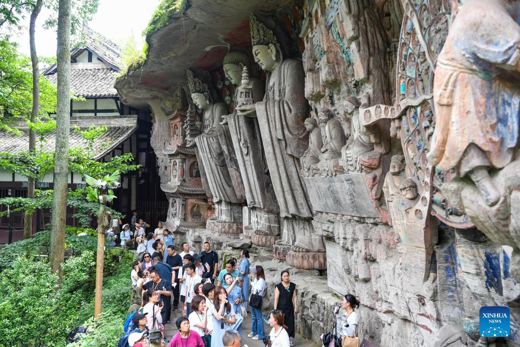 Tourists visit scenic spot of Dazu Rock Carvings in China's Chongqing