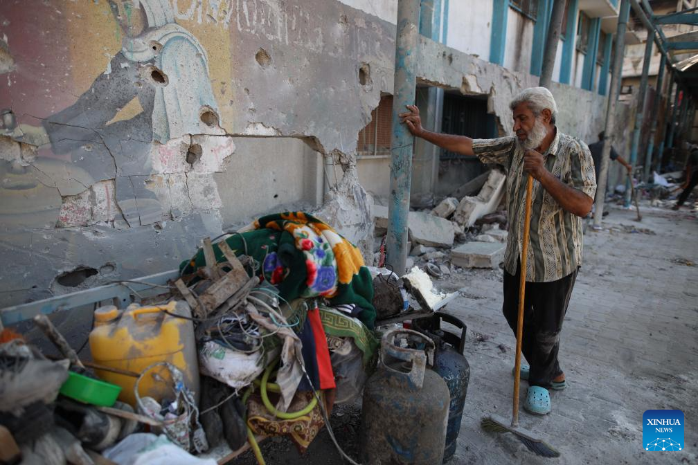 People conduct clean up work at UN-affiliated school after Israeli attack in Gaza