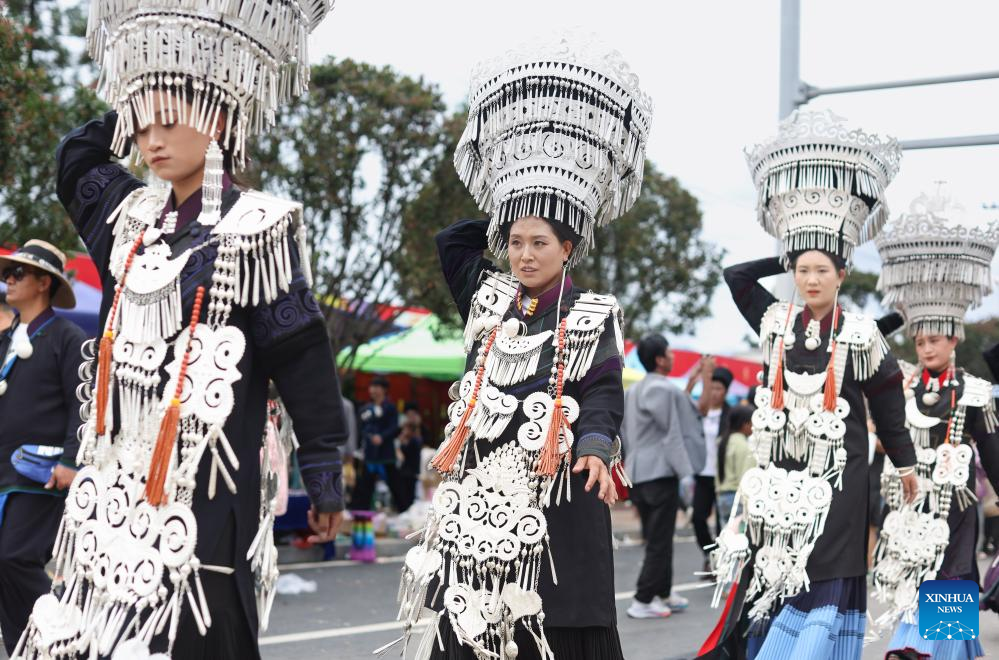 People dressed in traditional Yi costumes celebrate torch festival in China's Sichuan