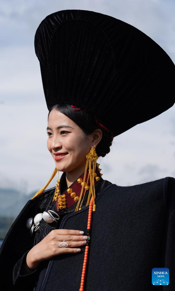 People dressed in traditional Yi costumes celebrate torch festival in China's Sichuan