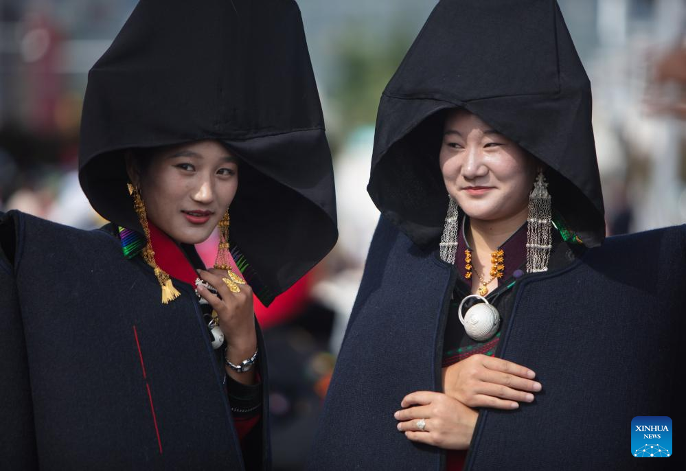 People dressed in traditional Yi costumes celebrate torch festival in China's Sichuan