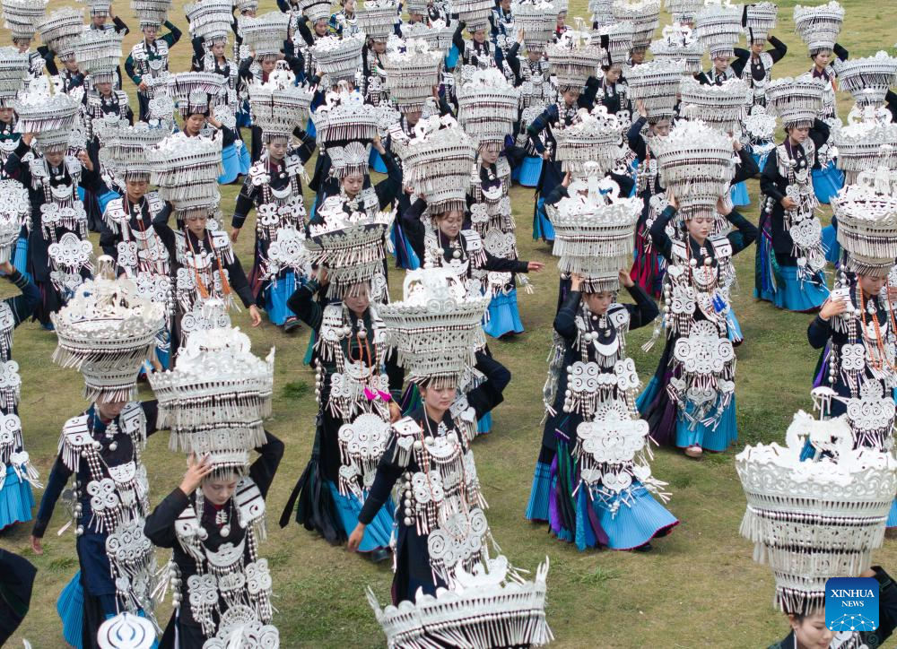 People dressed in traditional Yi costumes celebrate torch festival in China's Sichuan