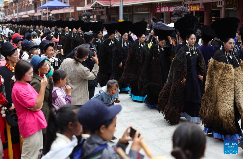 People dressed in traditional Yi costumes celebrate torch festival in China's Sichuan