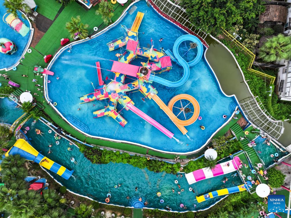 Tourists have fun at water park in Fuling District, SW China's Chongqing