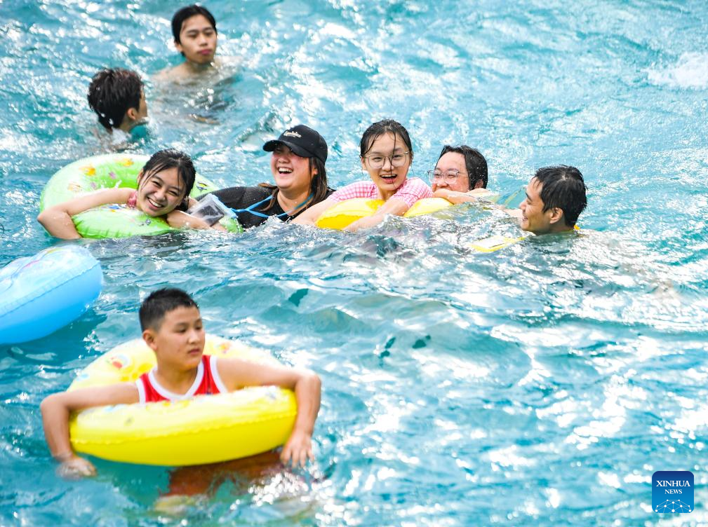 Tourists have fun at water park in Fuling District, SW China's Chongqing