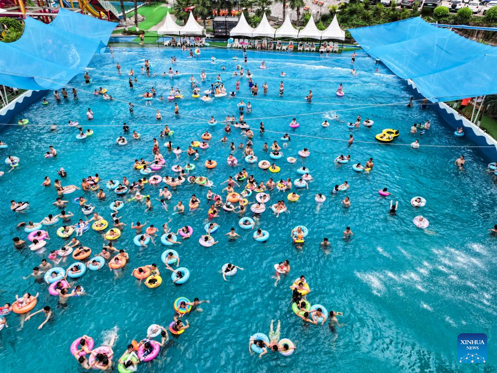 Tourists have fun at water park in Fuling District, SW China's Chongqing