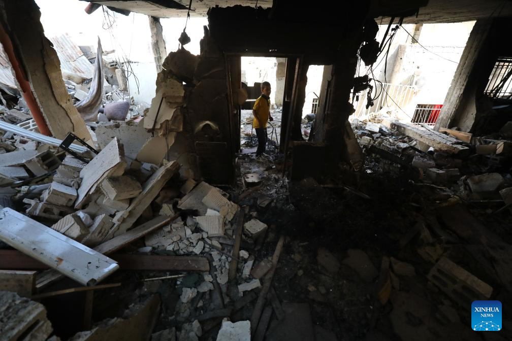 Palestinians check destroyed houses in Jenin