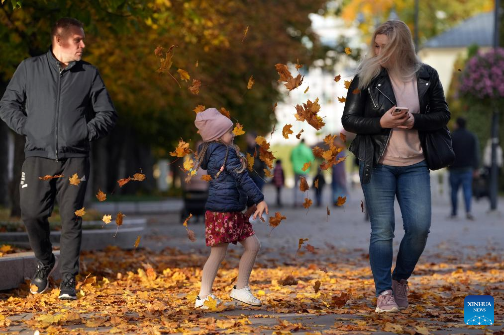 People enjoy autumn scenery in Ogre, Latvia