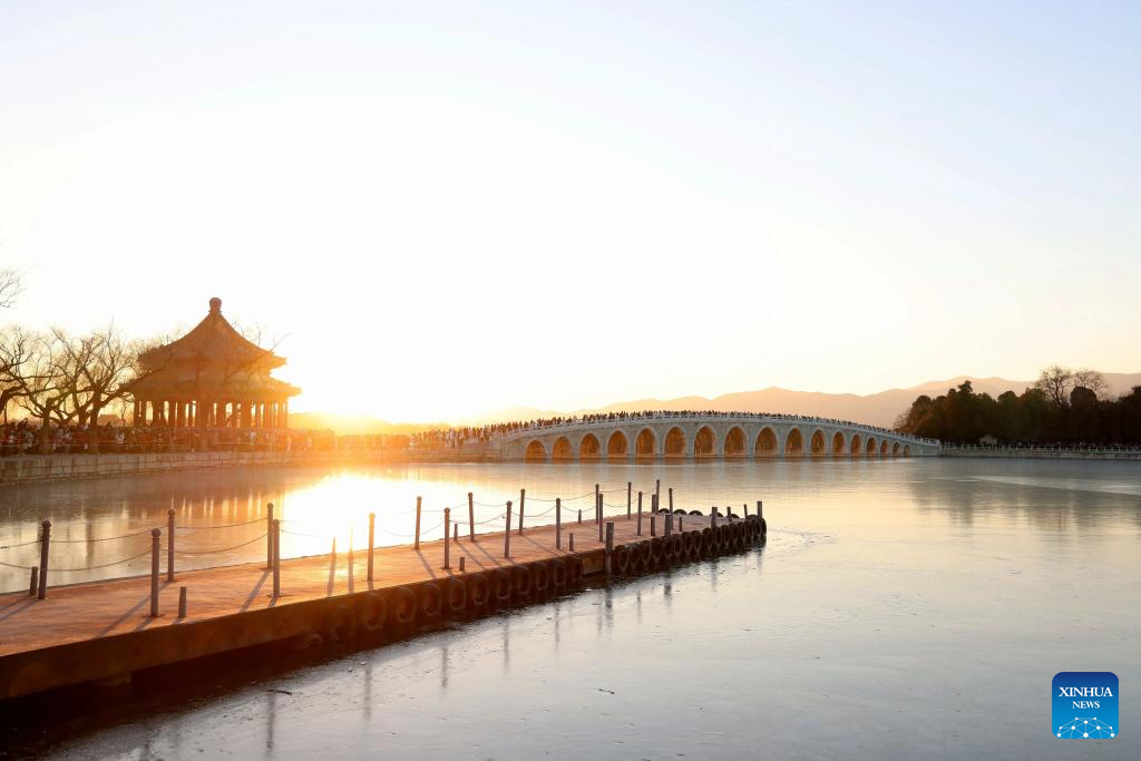 People visit 17-Arch Bridge in Summer Palace, China's Beijing