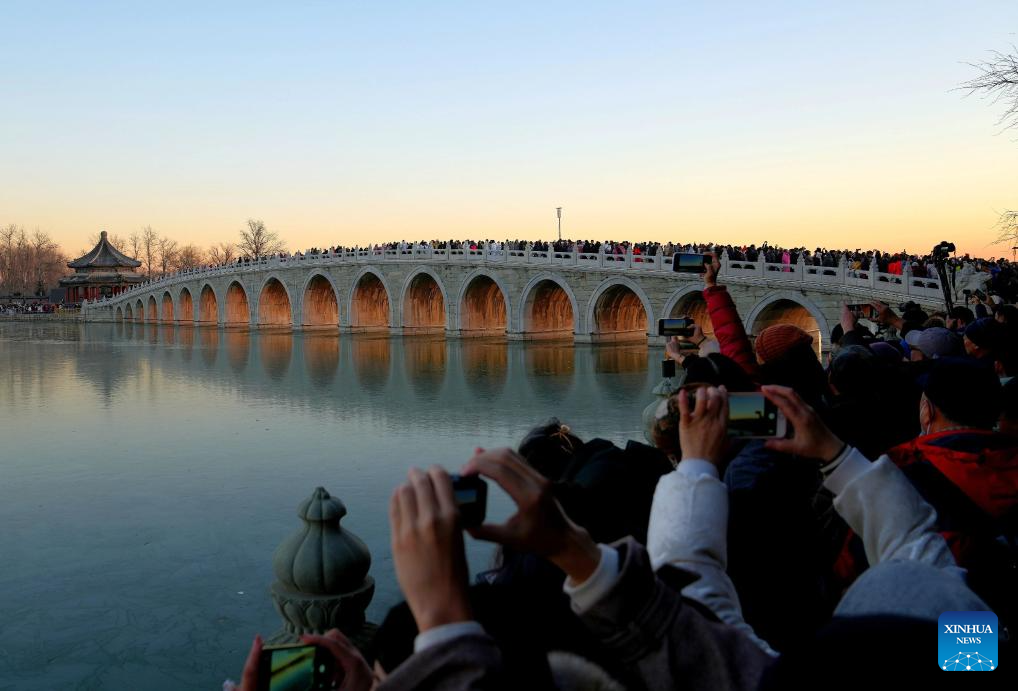 People visit 17-Arch Bridge in Summer Palace, China's Beijing