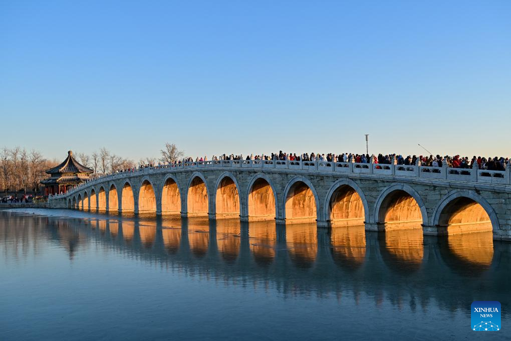 People visit 17-Arch Bridge in Summer Palace, China's Beijing