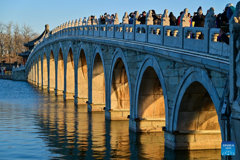 People visit 17-Arch Bridge in Summer Palace, China's Beijing