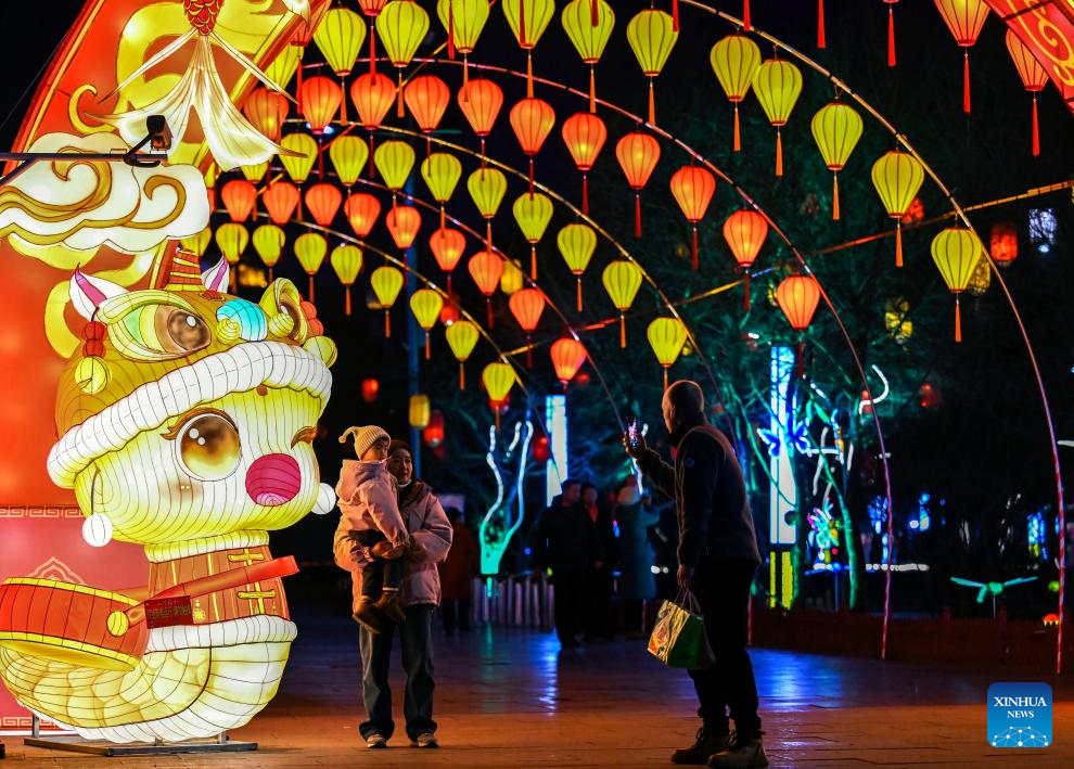 People enjoy light decorations in Hohhot ahead of Spring Festival