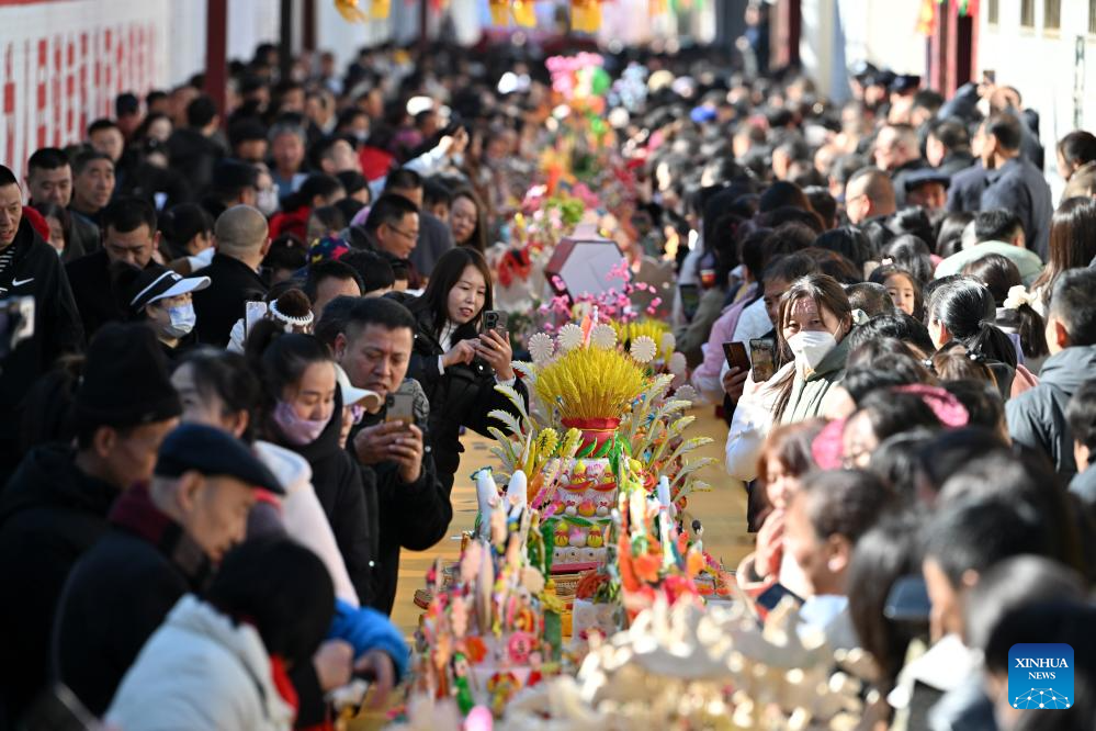 People view dough figurines in Lanxian County of China's Shanxi