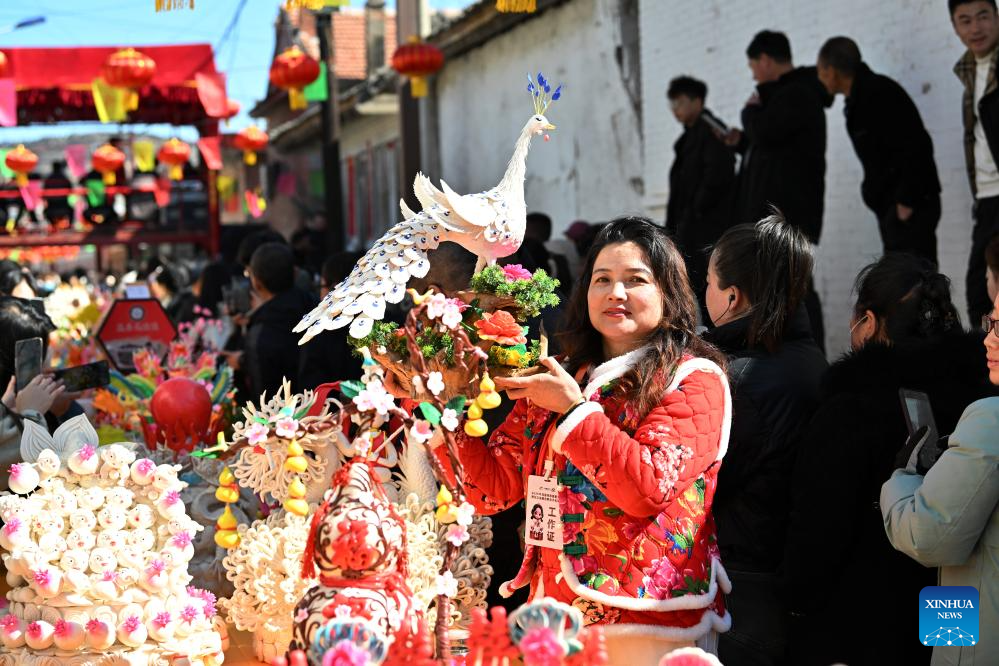 People view dough figurines in Lanxian County of China's Shanxi