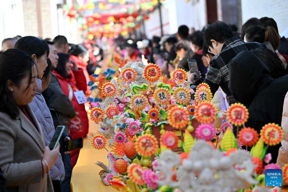 People view dough figurines in Lanxian County of China's Shanxi