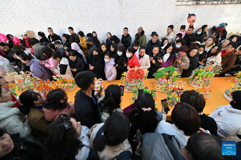 People view dough figurines in Lanxian County of China's Shanxi