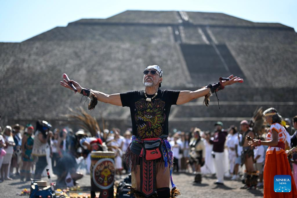 People bask in sunshine during Spring Equinox at Pyramid of Sun in Mexico