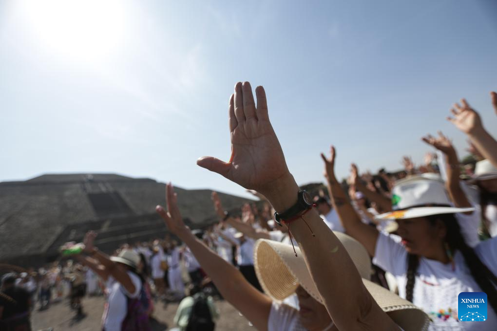 People bask in sunshine during Spring Equinox at Pyramid of Sun in Mexico