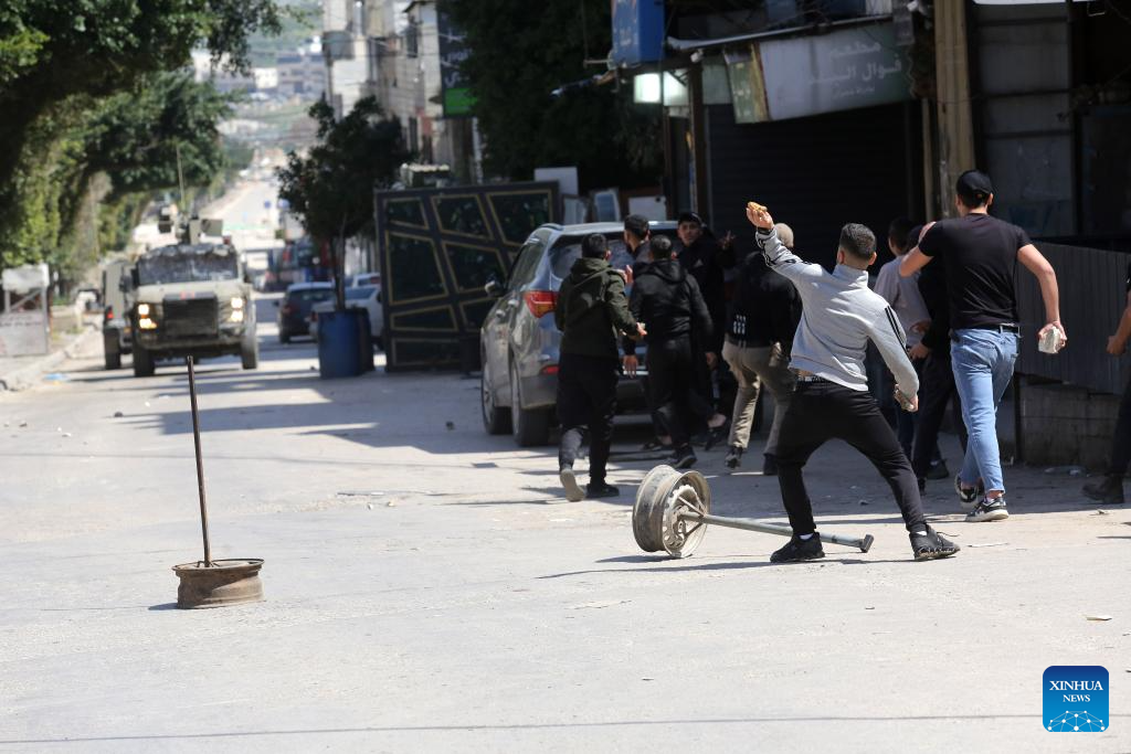 Palestinians confront Israeli forces during clashes at refugee camp in West Bank